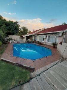 a swimming pool in the backyard of a house at PrimeStay One 2 Bedroom Apartment in Johannesburg