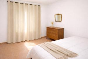 a bedroom with a bed and a dresser and a mirror at Navigo house Vrachati in Vrachati