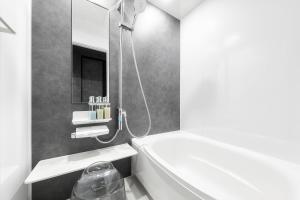a bathroom with a bath tub and a shower at The Elements in Nakafurano