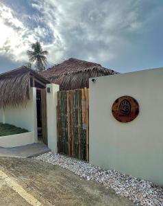 a building with a sign on the side of it at Ginhawa Stay Private Pool Studio in Burgos