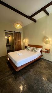 a bedroom with a large white bed with two pillows at Ginhawa Stay Private Pool Studio in Burgos