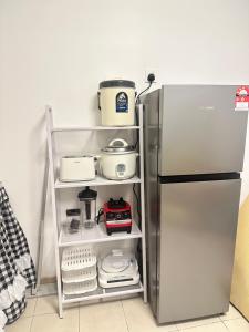 a refrigerator with its door open in a kitchen at HomestayBondaFaiiha in Port Dickson