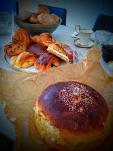 a table with a plate of pastries and a plate of bread at b&b les invités in Bruges