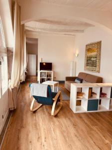 a living room with a couch and a chair at -Ortaflats- Appartamento Gli Archi in Orta San Giulio