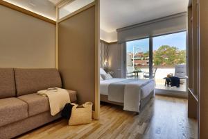 a hotel room with a bed and a couch at Bonanova Suite in Barcelona