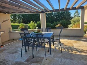 a blue table and chairs on a patio at Millésime in Perville