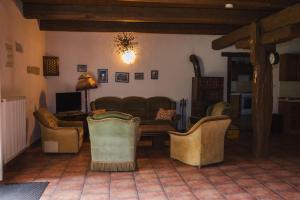 a living room with chairs and a couch and a table at Statek Vranč - stodola in Bítov