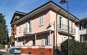 a pink building with a car parked in front of it at Rio Molino 1 in Stresa +15 photos