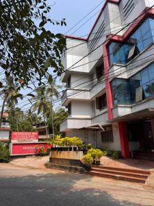a building with flowers in front of it at devanjana Guruvayur in Jāmb