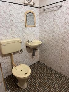 a bathroom with a toilet and a sink at devanjana Guruvayur in Jāmb +21 photos