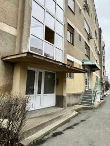 a building with a white door on the side of it at Apartament Atrium Gara Afi in Arad