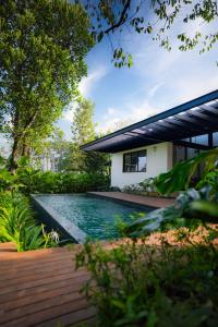 a swimming pool in the backyard of a house at The Villa - Premium Private Pool Villa in Vaduvanchal