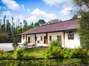 a small white house with a red roof at The Villa - Premium Private Pool Villa in Vaduvanchal