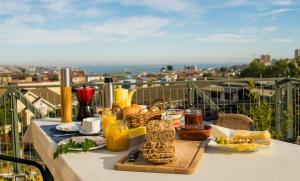 a table with a tray of food on a balcony at Pontoval B&B in Valparaíso