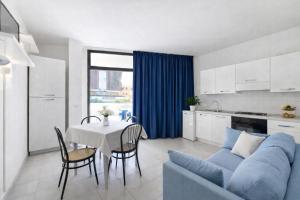a living room with a blue couch and a table at AMA Marena Apartments in Pesaro
