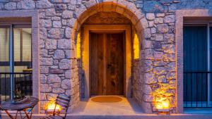 an entrance to a stone building with a wooden door at Moon Alaçatı adults only in Çeşme