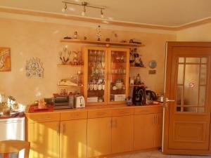 a kitchen with wooden cabinets and a microwave at Haus Janschütz in Flattach