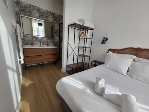 a bedroom with a bed and a bathroom with a sink at G4 - Appartement 2 ch Climatisé Centre Angoulême in Angoulême