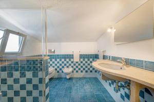 a bathroom with a sink and a toilet at Hotel Le Mimose in San Teodoro +51 photos