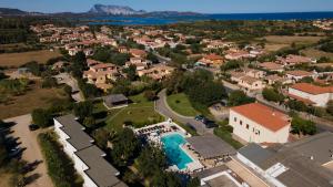 an aerial view of a house with a swimming pool at Hotel Le Mimose in San Teodoro