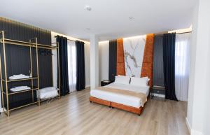 a bedroom with a bed and some windows at Oxygen Boutique Hotel in Tirana +216 photos