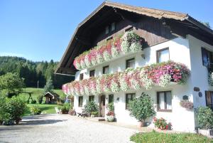 un edificio con flores a un lado. en Treindlhof, en Fuschl am See