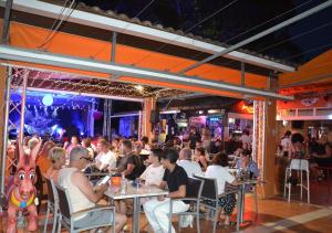 a group of people sitting at tables in a restaurant at Camping Les Salisses - Aquatique Vacances in Vias