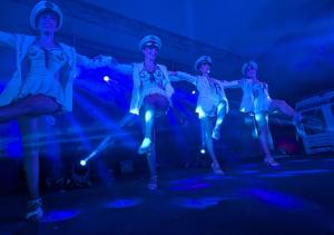 a group of dancers in a room with blue lights at Camping Les Salisses - Aquatique Vacances in Vias