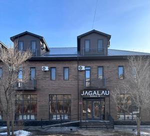 a large brick building with a jaguarova store at Jagalau in Balqash