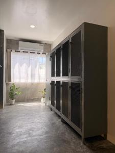 a locker room with black and white lockers at Cheevit Cheeva Koh Tao Hostel in Ko Tao