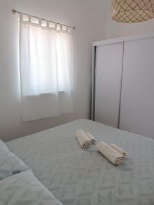 a bedroom with a bed with two towels on it at Apartment Elena in Sumartin