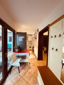 a living room with a table and a kitchen at Andrei's house in Sinaia +7 photos