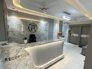 a lobby with a reception counter in a building at Hotel Palash Icon in Ahmedabad