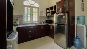 a kitchen with a stainless steel refrigerator and a sink at Eco Villa Resort in Negombo