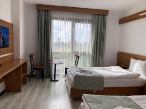 a hotel room with two beds and a window at BUSINESS EXPRESS HOTEL in Kapaklı +30 photos