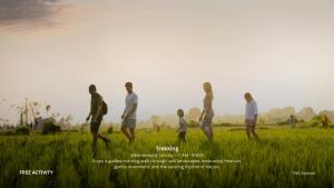 a group of people walking in a field at Sanctoo Suites & Villas in Gianyar