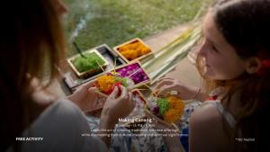 two young girls sitting at a table eating food at Sanctoo Suites & Villas in Gianyar
