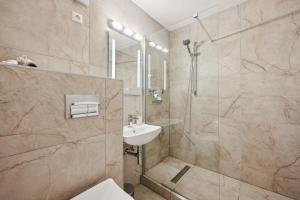 a bathroom with a shower and a sink at Ramoni Apartments - Abendgold in Enzklösterle +8 photos