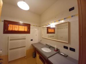 a bathroom with a sink and a mirror at Enoturismo Dofinè in Due Carrare