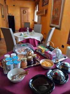 a table with a purple table cloth with food on it at Enoturismo Dofinè in Due Carrare