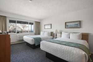 a hotel room with two beds and a window at Americas Best Value Inn Polson in Polson