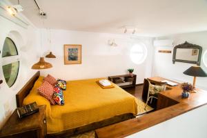 a bedroom with a bed and a desk and a mirror at Seafront Casa Azul Villa - Getaway in Kalymnos in Kalymnos +28 photos