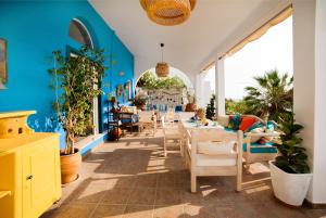 a dining room with blue walls and tables and chairs at Seafront Casa Azul Villa - Getaway in Kalymnos in Kalymnos