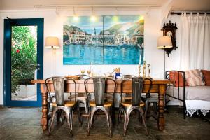 a dining room with a wooden table and chairs at Seafront Casa Azul Villa - Getaway in Kalymnos in Kalymnos