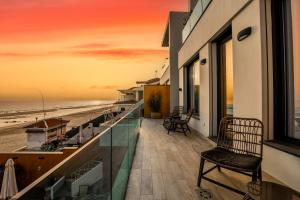 a balcony with a view of the beach at sunset at ON Village in Matalascañas