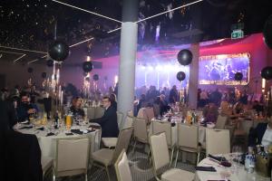 a group of people sitting at tables in a banquet hall at Hotel Verde City in Koszalin