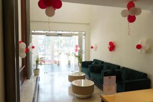 a living room with red and white balloons on the wall at Hotel Pacific Primee in Zirakpur