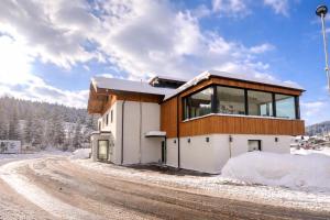 a house on the side of a snow covered road at Staminé in Hochfilzen