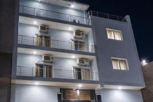 a white building with balconies on the side of it at Hotel Bhavishyaa Vrindavan in Vrindāvan