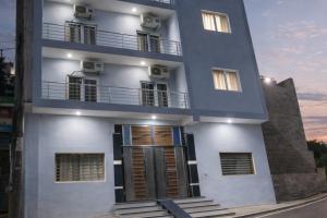 a white building with a door and a balcony at Hotel Bhavishyaa Vrindavan in Vrindāvan +11 photos